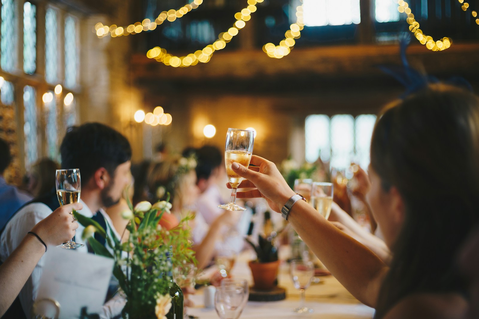 Guests raising champagne glasses at a sophisticated private event